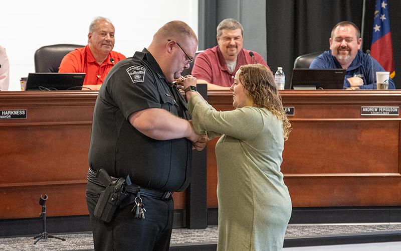 Steven Squires was promoted to training sergeant as his wife, Breanna Squires, pinned the new badge on during Tuesday night’s called meeting. ZACH TAYLOR/Staff