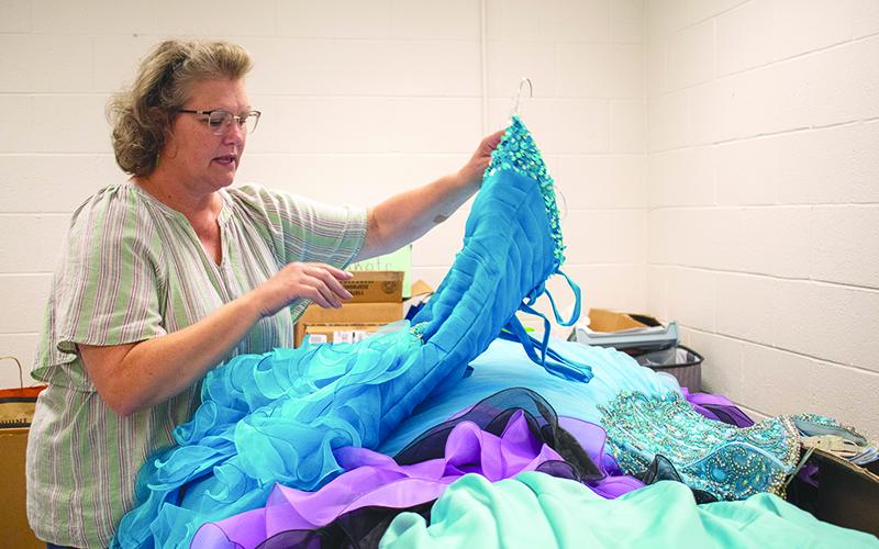 Habersham County Family Connection Executive Director Donna Barrett sorts through donated dresses. JULIANNE AKERS/Staff