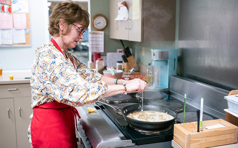 Nationally acclaimed Chef Inger Smith squeezes lemon juice onto the chicken as it cooks. Smith is all about preparing healthy meals for everyone. ZACH TAYLOR/Staff