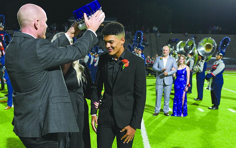 HCHS Principal Dr. Adam Bagwell places the crown atop 2024 Homecoming King Trey King.  TOM ASKEW/Special