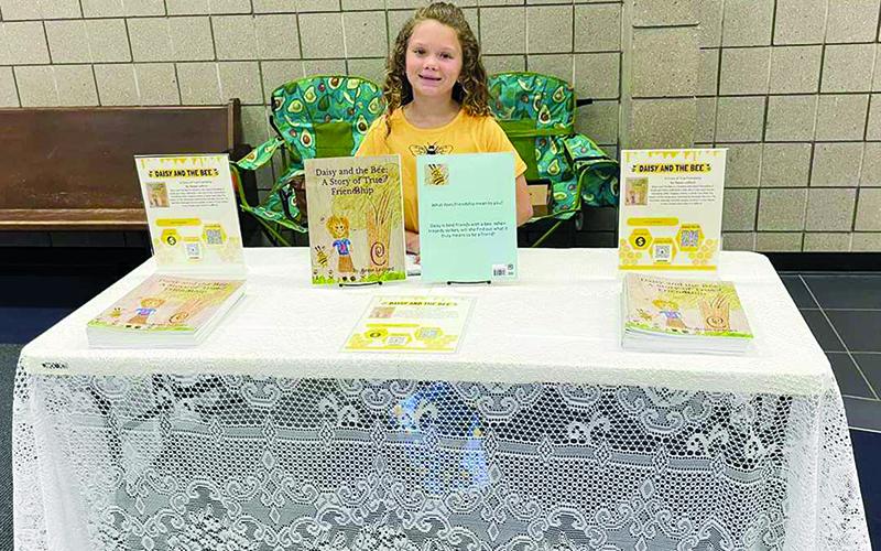 Reese Ledford tables at the Habersham County Chamber of Commerce Junior Business fair in April. SUBMITTED