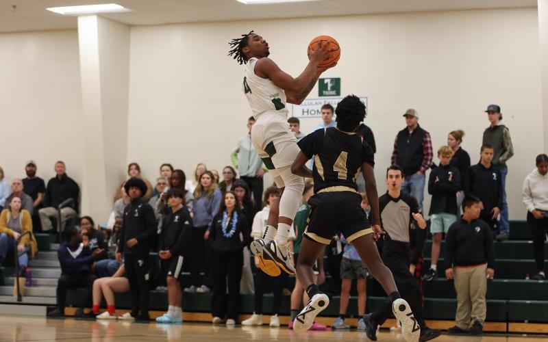 TFS’ Neyo Bain drives to the hoop during a game last season. AUSTIN POFFENBERGER/Special