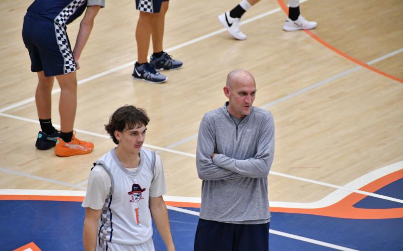 Raider’s guard Caden Garrison (left) and Coach Tommy Yancey crack a joke during practice earlier this week. LANG STOREY/Staff