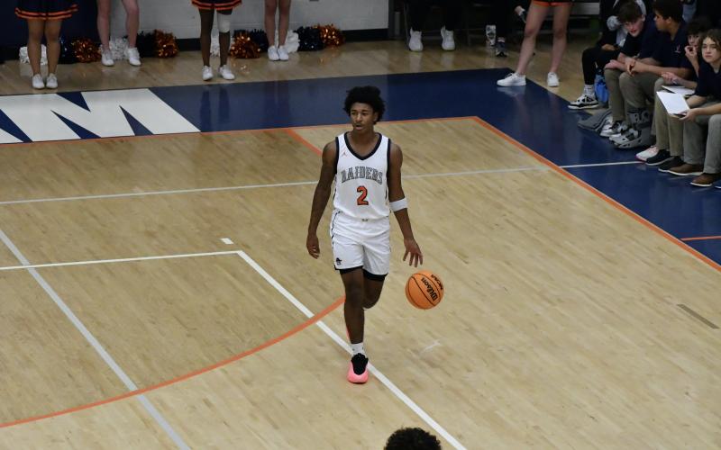 Enzo Combs surveys the floor during the first half of Habersham’s win over White County Tuesday. LANG STOREY/Staff