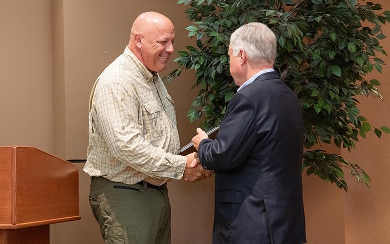 Habersham County Farm Bureau President Chip Brooks presents the Friend of Agriculture Award to NGTC President John Wilkinson. ZACH TAYLOR/Staff