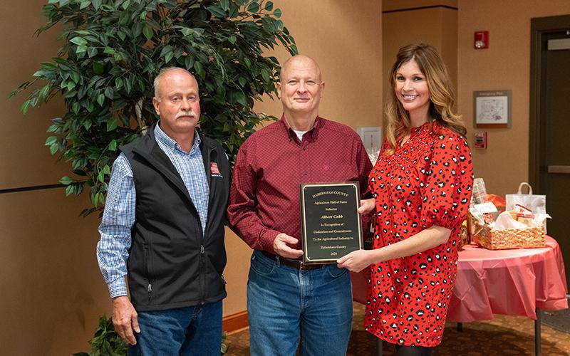 Farm Bureau Board Member Jimmy Kowalsky and Habersham Rotary’s Mary Beth Horton present the Habersham County Agricultural Hall of Fame Induction of Albert Cobb to Greg Day. ZACH TAYLOR/Staff