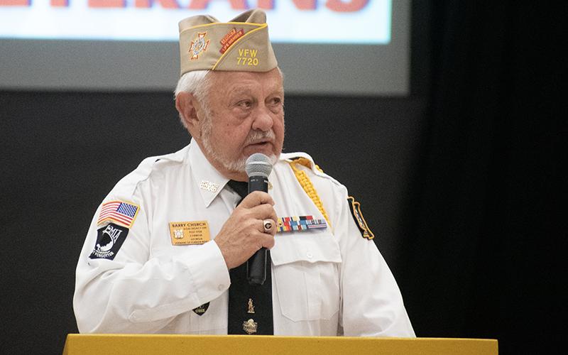 Grant-Reeves VFW Post 7720 Commander Barry Church spoke to veterans and students at Monday morning’s program. JULIANNE AKERS/Staff