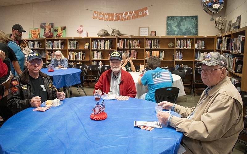 Veterans Mike Byokawski, John Ott and John Moon enjoy breakfast at a reception that followed Monday’s program. JULIANNE AKERS/Staff