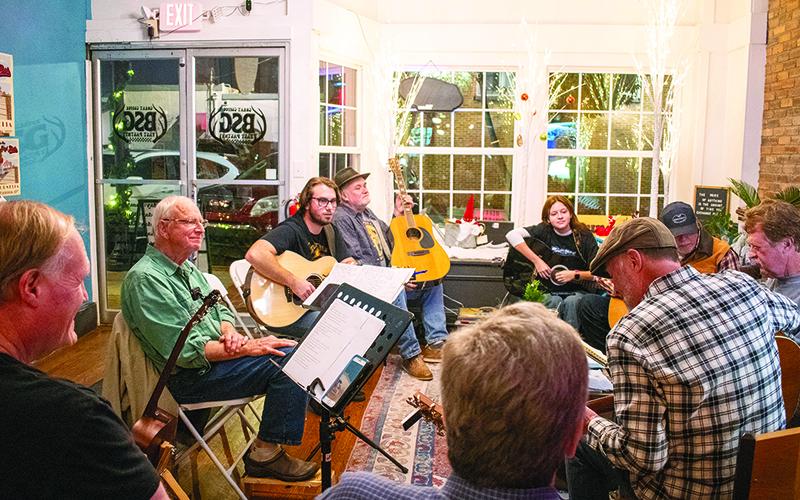 The acoustic circle meets at the front of BSG Coffee &amp; Cafe. Pictured from left are Stan Crump, Larry Parham, Alex Marineau, Eric Rider, MaClaine Wheeler, Alan Laney, David Green, Tim Green and Jimmy Maness. JULIANNE AKERS/Staff