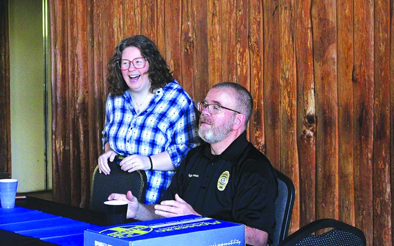 Krystal Risher (left) and Sgt. Deloney Gunnels (right) laugh with a friend during the celebration of Gunnels’ retirement. Risher, who is Gunnels’ daughter, said she is very proud of her father’s accomplishments. HANNAH CAUDELL/Staff