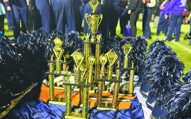 The Band of Blue’s host of trophies sit on the field. SUBMITTED