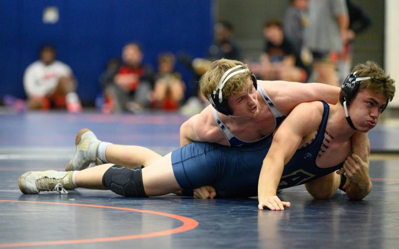 Justin Whitney, seen here pinning an opponent, will look to qualify for State just as he did last season. LANG STOREY/Staff