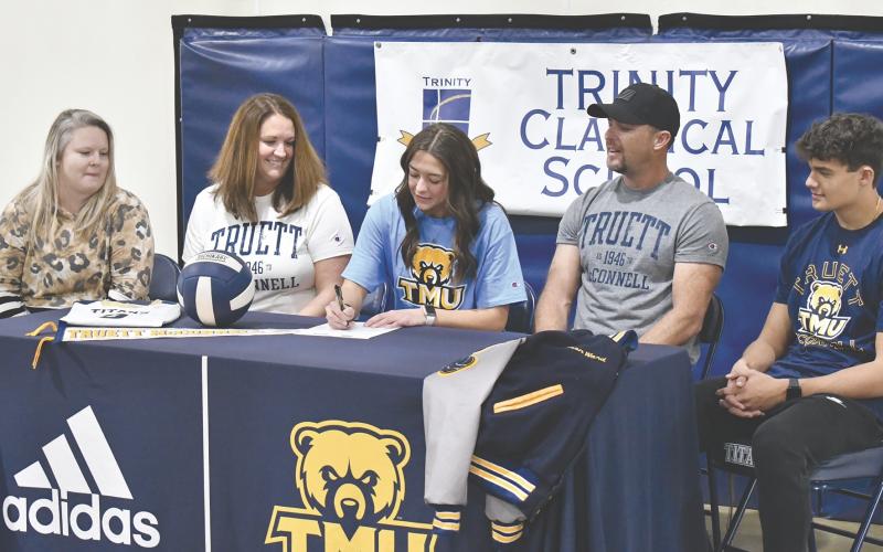 Surrounded by her family and TCS’ Celina Chitwood, Madison Ward put ink to paper Friday, making her commitment to Truett McConnell official. LANG STOREY/Staff