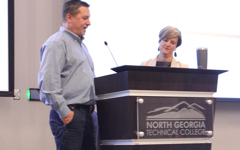 From left, Ty Akins and Alicia Vaughn talk economic development at the State of the County address on Tuesday. HANNAH CAUDELL/Staff