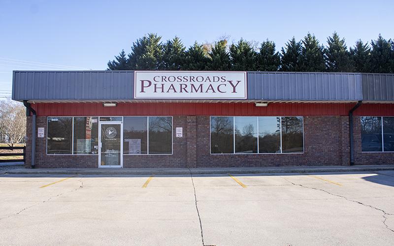 Crossroads Pharmacy sits vacant in its lot in Demorest. In the window, a sign sits that redirects customers to Walgreens for their prescriptions. HANNAH CAUDELL/Staff