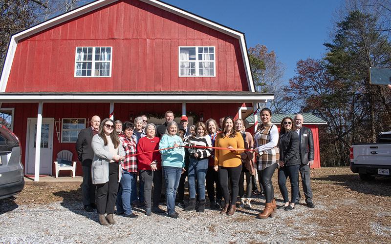 Members of the board and staff of Family Promise of White and Habersham and the Habersham County Chamber of Commerce cut the ribbon on the Family Promise’s new Clarkesville location. JULIANNE AKERS/Staff