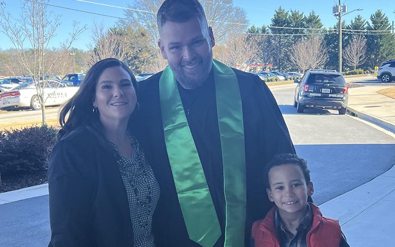 From left, Rachel and graduate Joey Newkirk stand with their son, Elijah, for a photo. Officer Newkirk said graduating with a college degree was his way of showing his son that he can accomplish whatever he puts his mind to. SUBMITTED