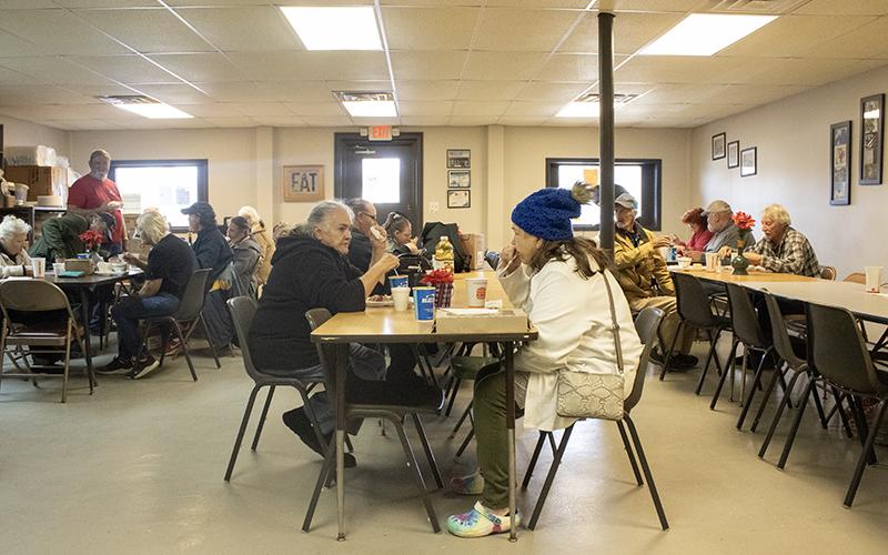 From left, Jennie Tomlin sits and chats across the table from Diane Higgins, who enjoys a warm cup of chili on a cold December day. HANNAH CAUDELL/Staff