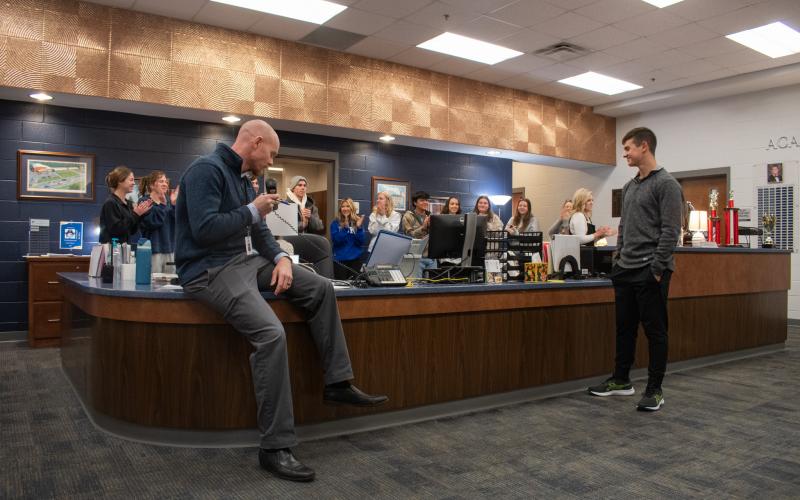 Habersham Central Principal Dr. Adam Bagwell announces Joshua Burris as the 2025 STAR Student recipient for the school, as Burris’ peers clap for him behind the front office desk. HANNAH CAUDELL/Staff