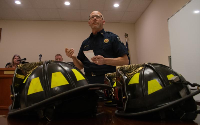 Baldwin Fire Chief Joe Roy stands before the audience at the Baldwin City Council meeting on Monday night to talk about Baldwin’s first department graduating class. New firefighter helmets sat on the table before him. Helmets are traditionally given to new firefighters upon graduation. HANNAH CAUDELL/Staff