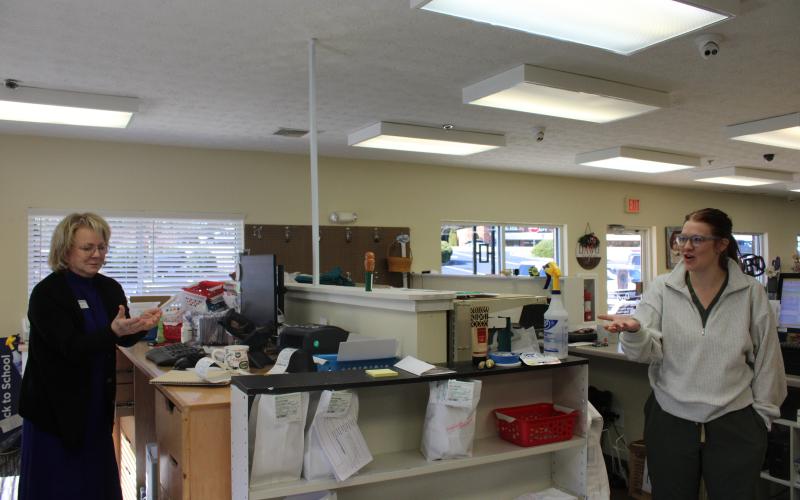 From left, Habersham Drug owner Deborah Gale stands behind the pharmacy counter with her daughter, Hannah. HANNAH CAUDELL/Staff