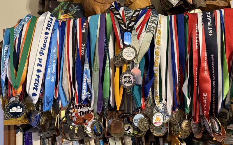 The Turner house in Clarkesville is home to hundreds of race medals acquired through the years. LANG STOREY/Staff