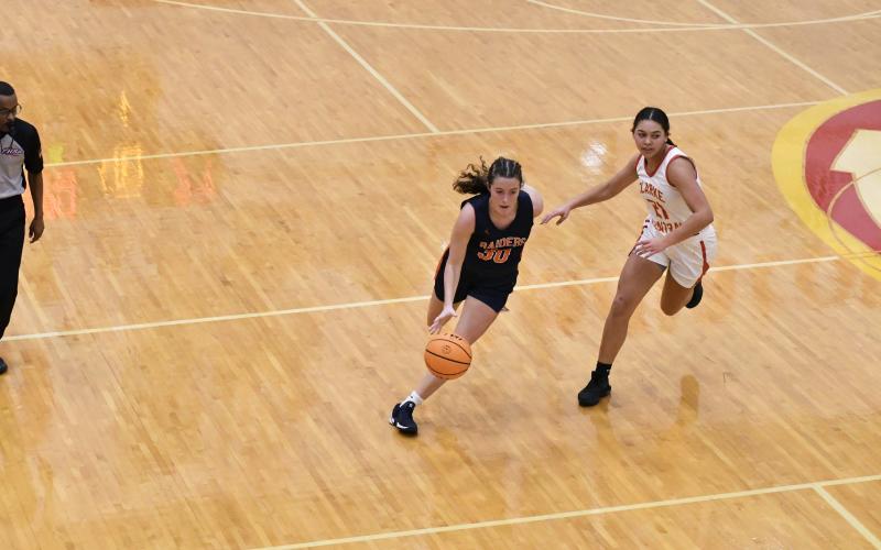 Senior Paisley Cathey breezes past a Clarke Central defender. Cathey helped the Lady Raiders move the ball offensively and finished with a team-high 5 assists. LANG STOREY/Staff