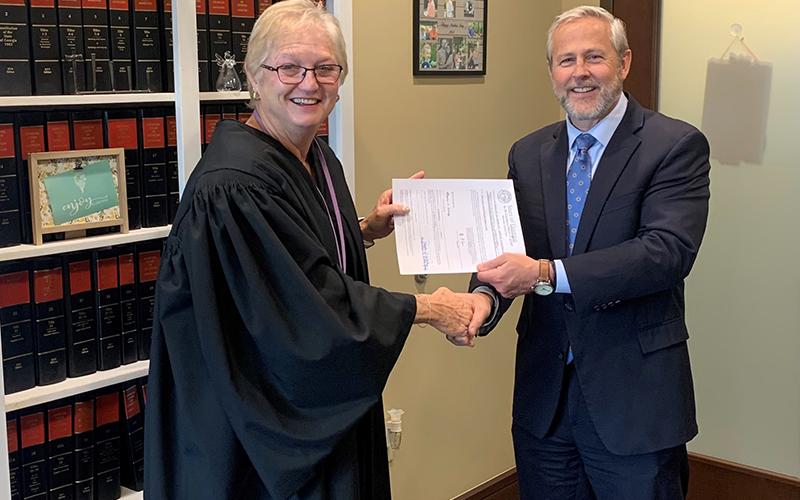 Probate Judge Pamela Wooley, left, shakes hands with Superior Court Judge Chan Caudell in a swearing-in ceremony in December. HABERSHAM COUNTY/Submitted