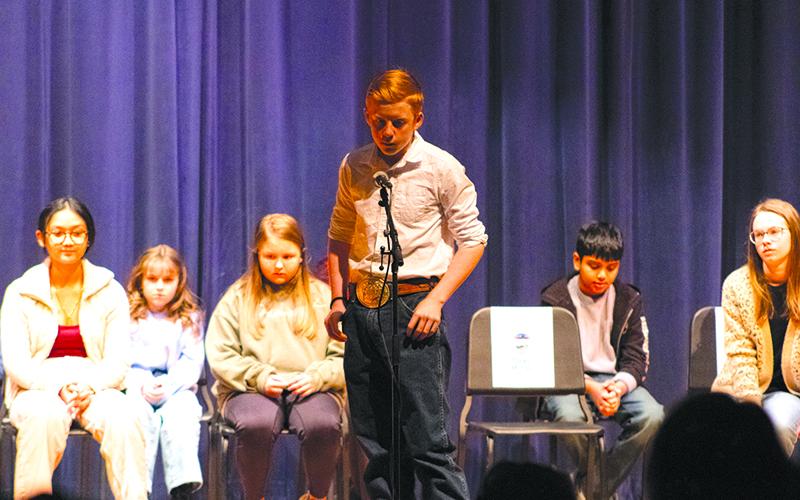 South Habersham Middle School Student Blake McCall spells a new word very carefully before returning to his seat on stage. HANNAH CAUDELL/Staff