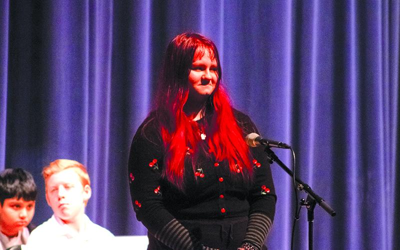 Sophie Roberts smiles as Dr. Adam Bagwell tells her and the audience that the next word is a homonym. HANNAH CAUDELL/Staff