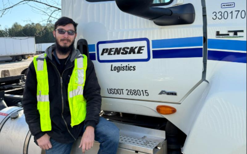 Penske Logistics Truck Driver William Mitchell of Alto is pictured with the Penske truck he drives. Mitchell was responsible for saving the life of a pickup truck driver after witnessing a crash between the pickup truck and a fuel tanker. SUBMITTED