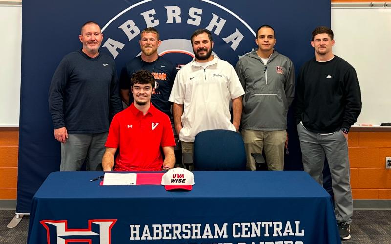 HCHS senior Everett Rudeseal officially put pen to paper last week. Much of the Habersham Football staff - including (from left) Coach Benji Harrison, JR Roberson, Drew Ferguson, Isaiah Murphy and Garrett Kinsey - were in attendance to witness. SUBMITTED