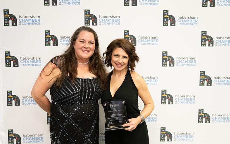 Chamber President Ellie Van Doornum (left) presents Amanda Fulmer (right) with the Entrepreneur of the Year Award. ZACH TAYLOR/Staff