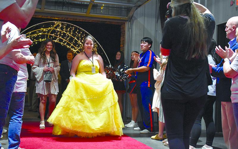 Tiffany Flack stands out on the red carpet in her yellow Belle gown. SAMANTHA SINCLAIR/Staff