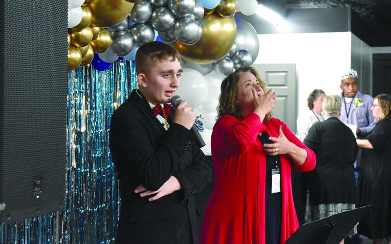 Leland Hix sings ‘Just the Way You Are’ as Dara Trull signs the words. SAMANTHA SINCLAIR/Staff