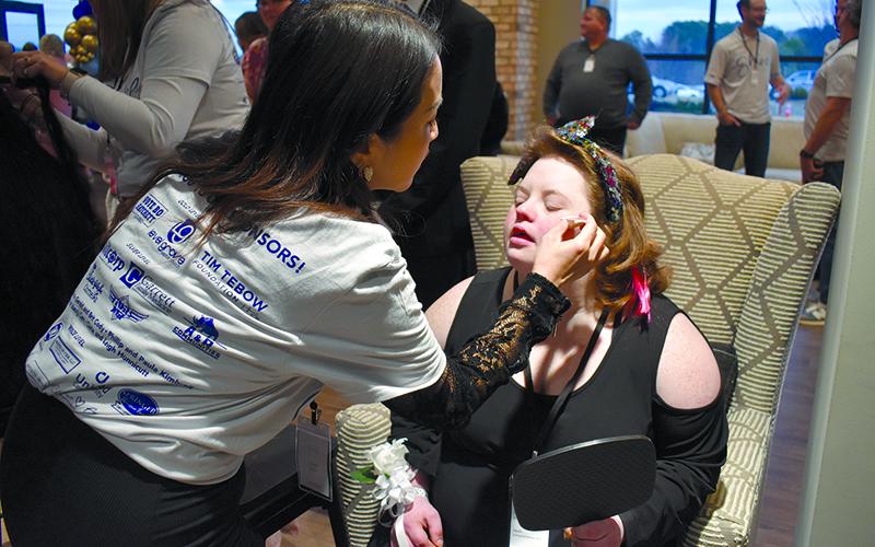 Habersham Central cosmetology teacher Susan Yang applies blush to Danielle Buffington’s cheek. SAMANTHA SINCLAIR/Staff