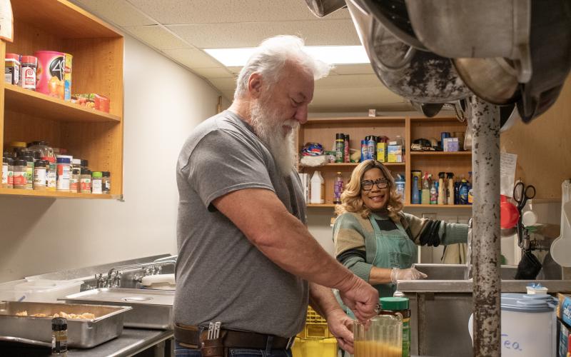 Married duo Bill and LeeAnn Waller prepare food and drinks on an early Saturday morning before guests arrive at the Cornelia “Lord’s Help” Soup Kitchen. HANNAH CAUDELL/Staff