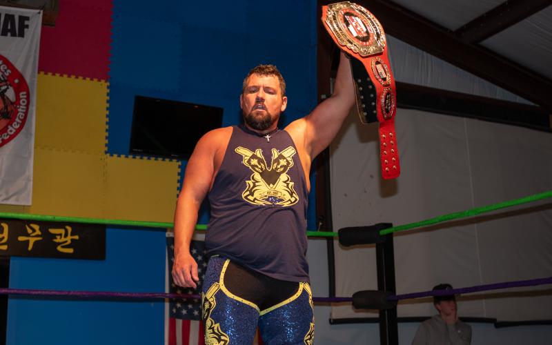 Billy Buck holds up the SFCW belt after his win over Rinauro. ZACH TAYLOR/Staff