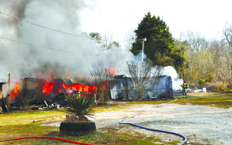 Firefighters work to extinguish a double wide home engulfed in flames on Ga. 115 in the Fairview community west of Clarkesville. Submitted