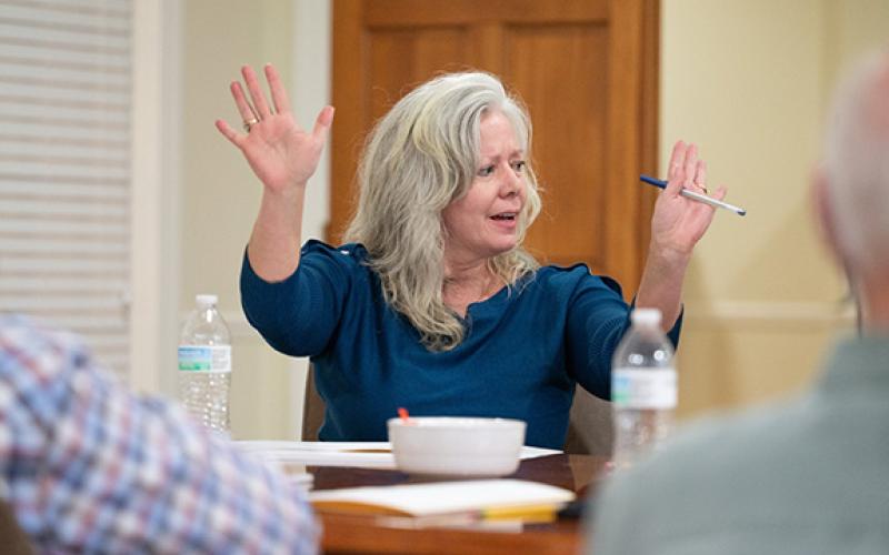 Councilwoman Angelia Kiker raises her hands in joy after a unanimous vote to purchase the old courthouse property for $1.19 million. Kiker was the main driving force behind the city's historic purchase. (Zach Taylor/Staff)