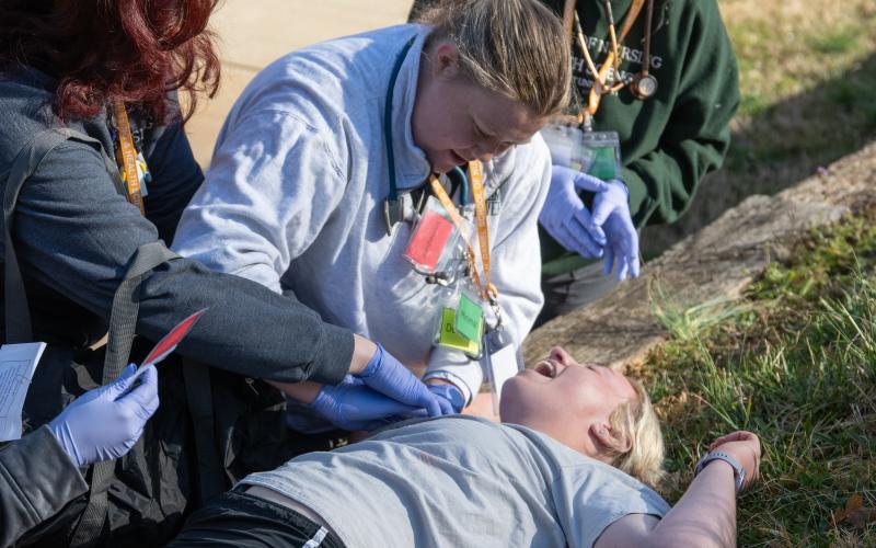 Piedmont nursing student Gracie Martin puts pressure on a gunshot wound during the disaster drill. Nursing students got a firsthand look at what a chaotic scene in the real world could look like. ZACH TAYLOR/Staff