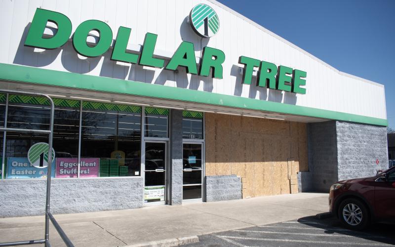 The right side of the Dollar Tree storefront in Clarkesville is boarded with plywood after Friday’s crash, when a motorist accidentally drove into the building. HANNAH CAUDELL/Staff