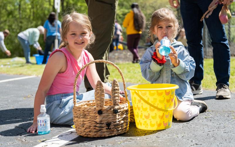 Scotlynn Taylor and Rynlee Leviner enjoy Tummy Yummies and sort their candy after the Mt. Carmel Baptist Church Easter Egg Hunt. The church held several different egg hunts for different age groups, including a tinsel-filled kid's pool for babies to hunt Easter eggs in. ZACH TAYLOR/Staff