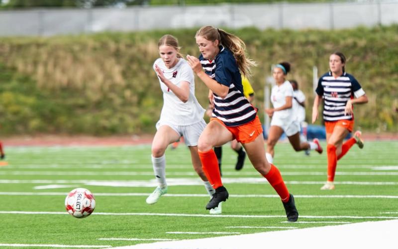 Habersham's Emmie Kyle beats a Lee County defender to the punch during the Lady Raiders' first round matchup. HABERSHAM SOCCER