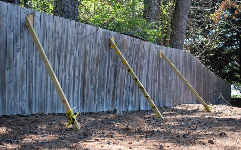 Some of the fence posts at the Lee Dorsey Cook playground must be propped up to maintain the integrity of the deteriorating structure. The town of Alto will be replacing those wooden slats soon with a new chain link fence. HANNAH CAUDELL/Staff