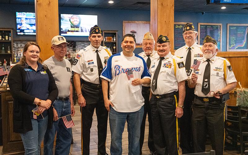 Saravia poses with the Grant-Reeves Honor Guard, comprised of Bill McAllister, American Legion Post 84 Commander Jim Morgan, VFW Post 7720 Commander Barry Church, Dr. Ed Hendricks, Robert Trousdale and Kenneth Franklin alongside DAV Chapter 15 Commander Amanda Doughty. ZACH TAYLOR/Staff