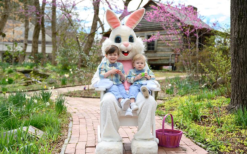 Owen and Isaac Crawford smile for a photo with the Easter Bunny behind the Mauldin House in Clarkesville. FILE