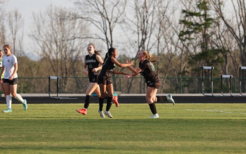 TIN POFFENBERGER/Special Lady Indians’ players (from left) Ryleigh Wilson, Lizzie Huebner and Miah Gragg celebrate a TFS goal earlier this spring.