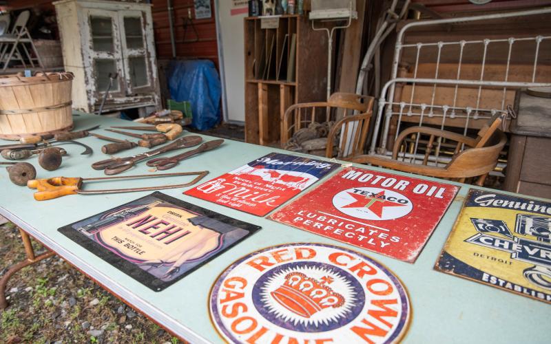 Vintage signs from motor oil companies to old hand tools and bed frames sit in the outdoor portion of the antiques store. ZACH TAYLOR/Staff