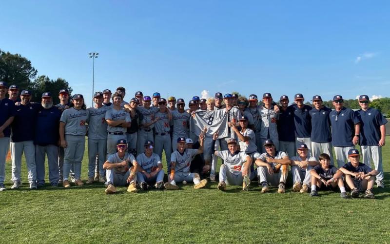 The Diamond Raiders pose around Gage Teague’s No. 8 jersey following the team’s win to advance to the GHSA Elite 8 Wednesday at South Paulding. SUBMITTED